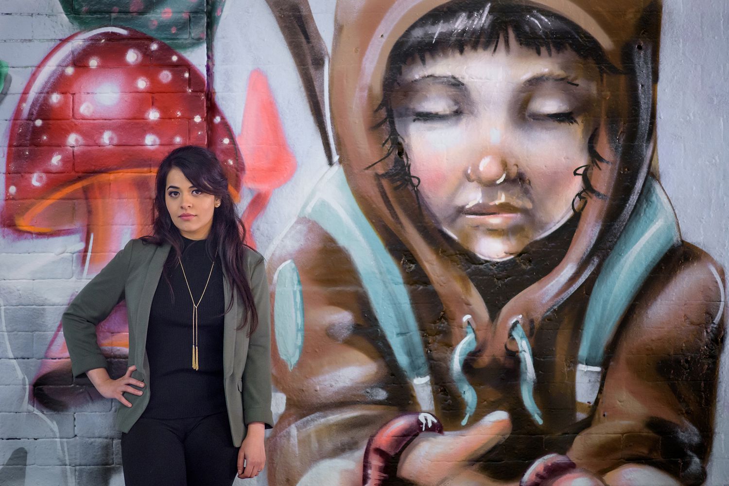 Artistic urban portraits against colorful graffiti murals in a modern city setting.