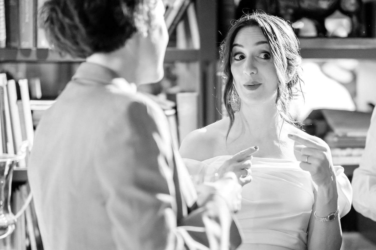 Black and white candid shots of wedding guests during reception celebrations.