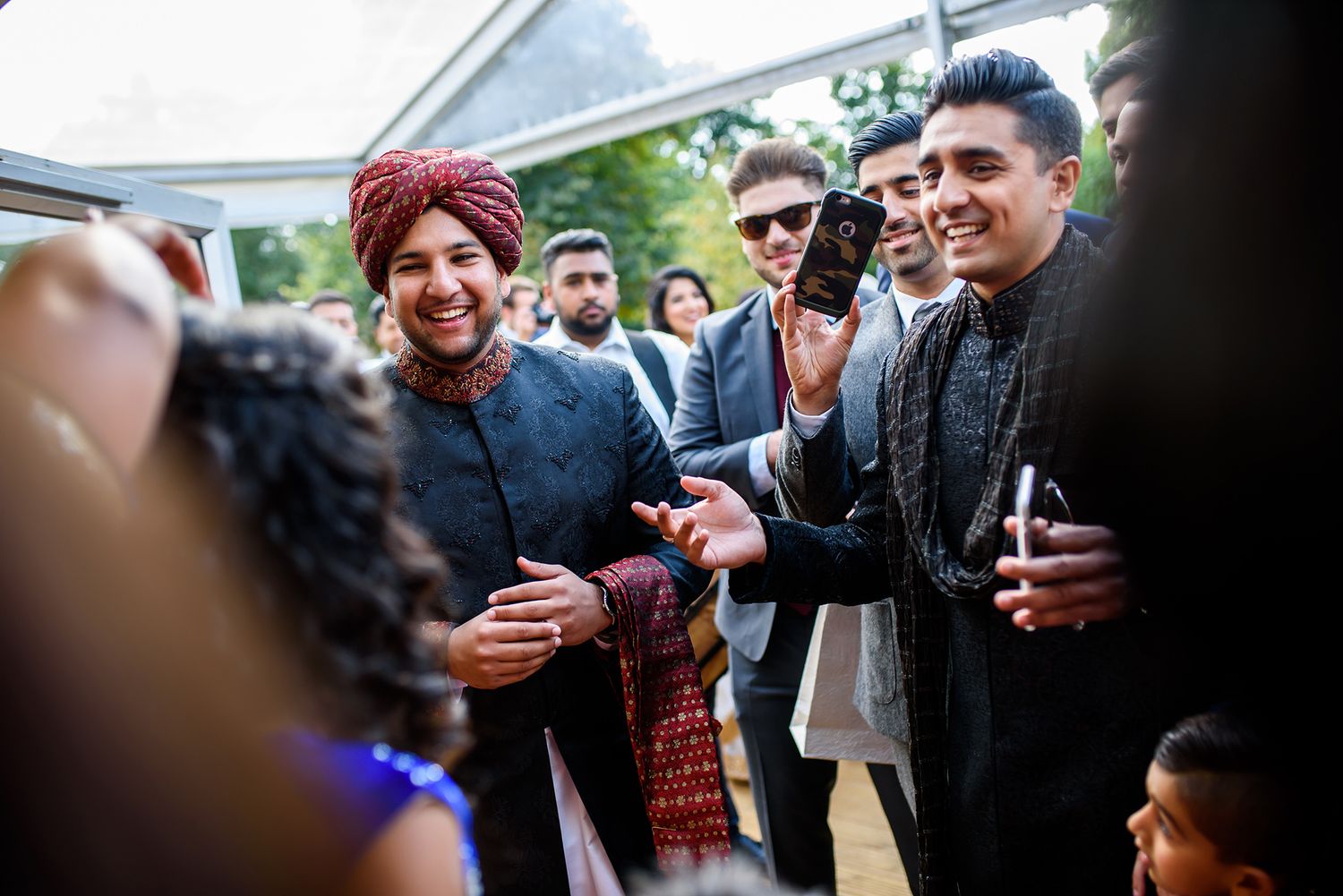 Joyful celebration with guests mingling at an outdoor wedding event.