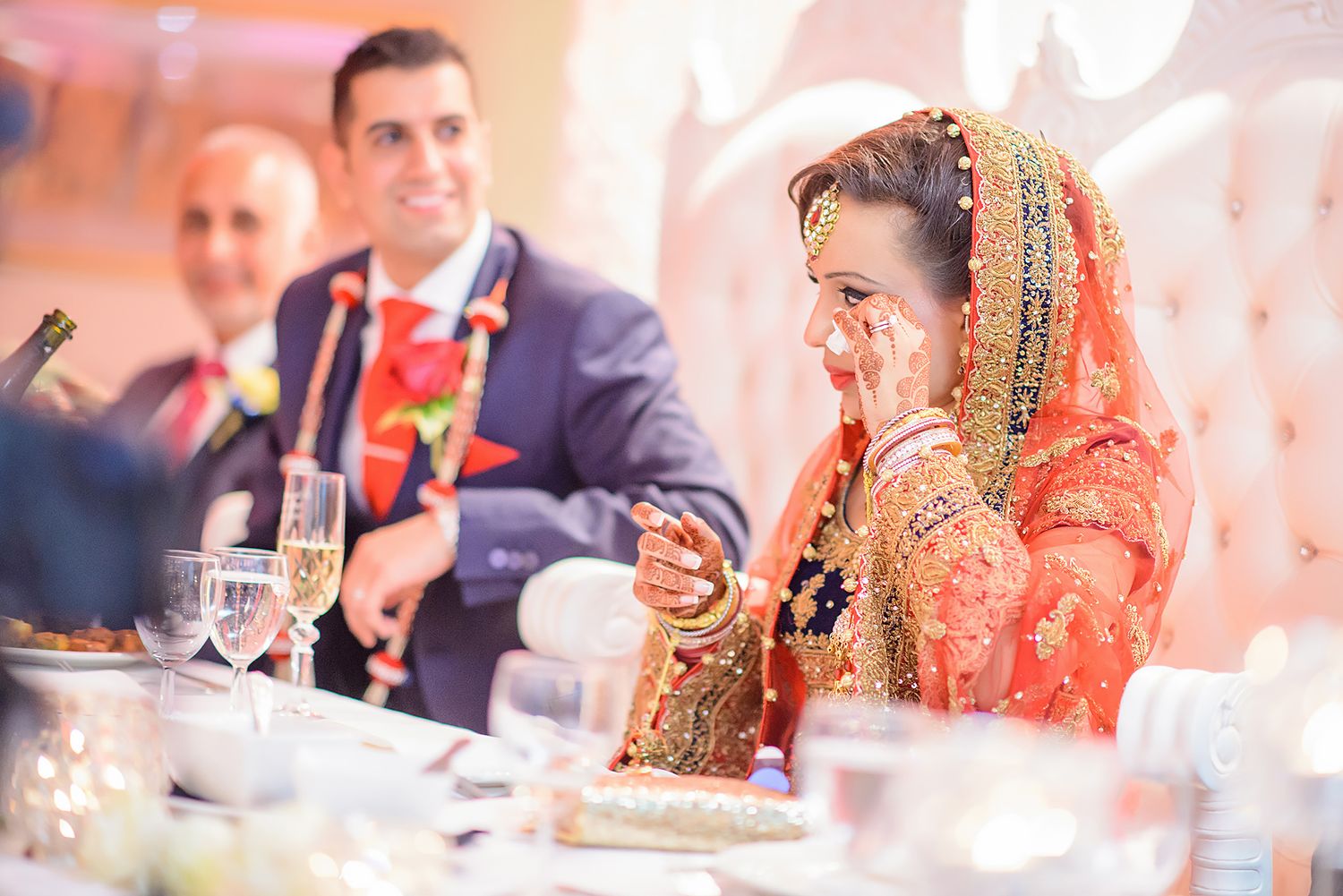 Wedding reception guests enjoying formal dinner celebration with elegant table settings.