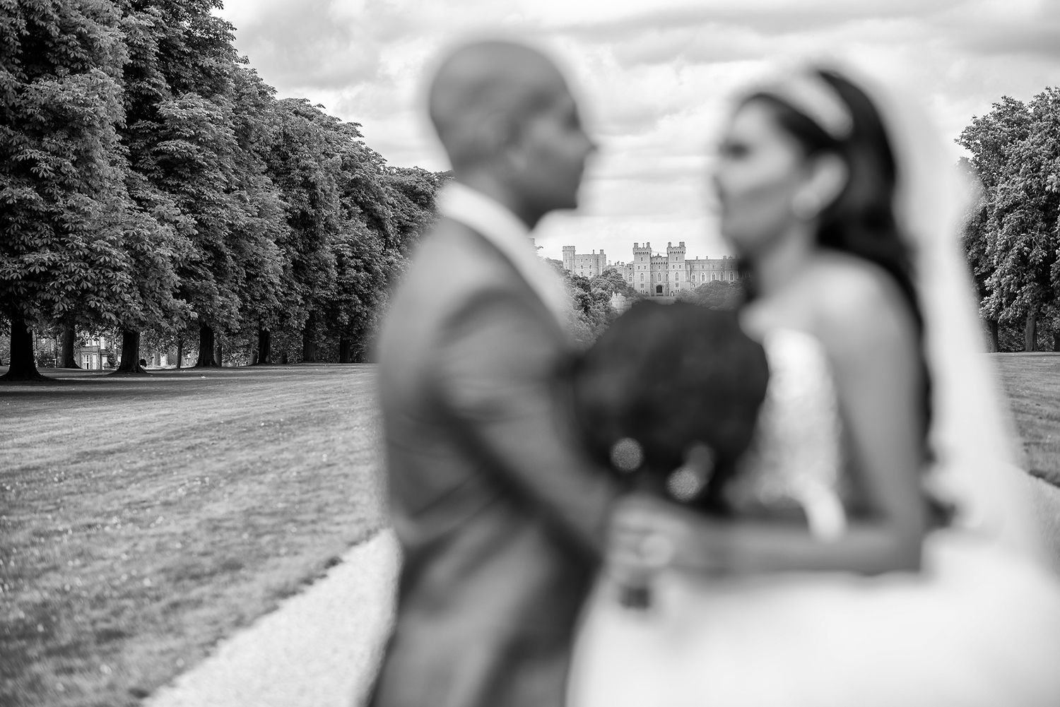 Black and white landscape shot of wedding celebration outside historic church.