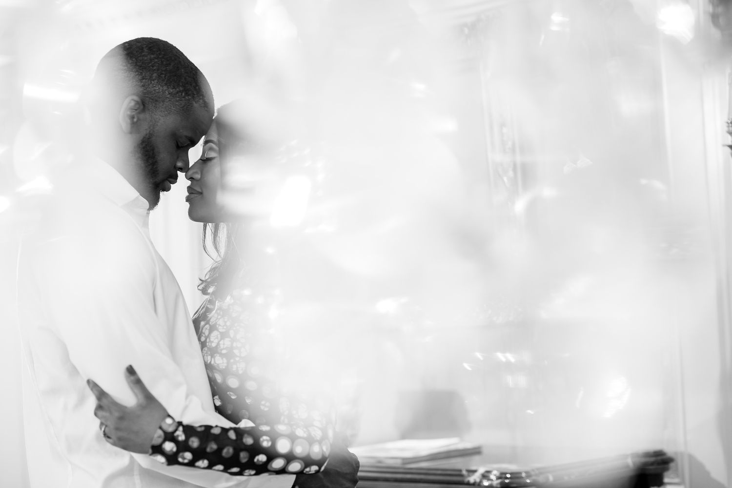 Ethereal bridal portrait with soft focus and dreamy smoke effects in monochrome.