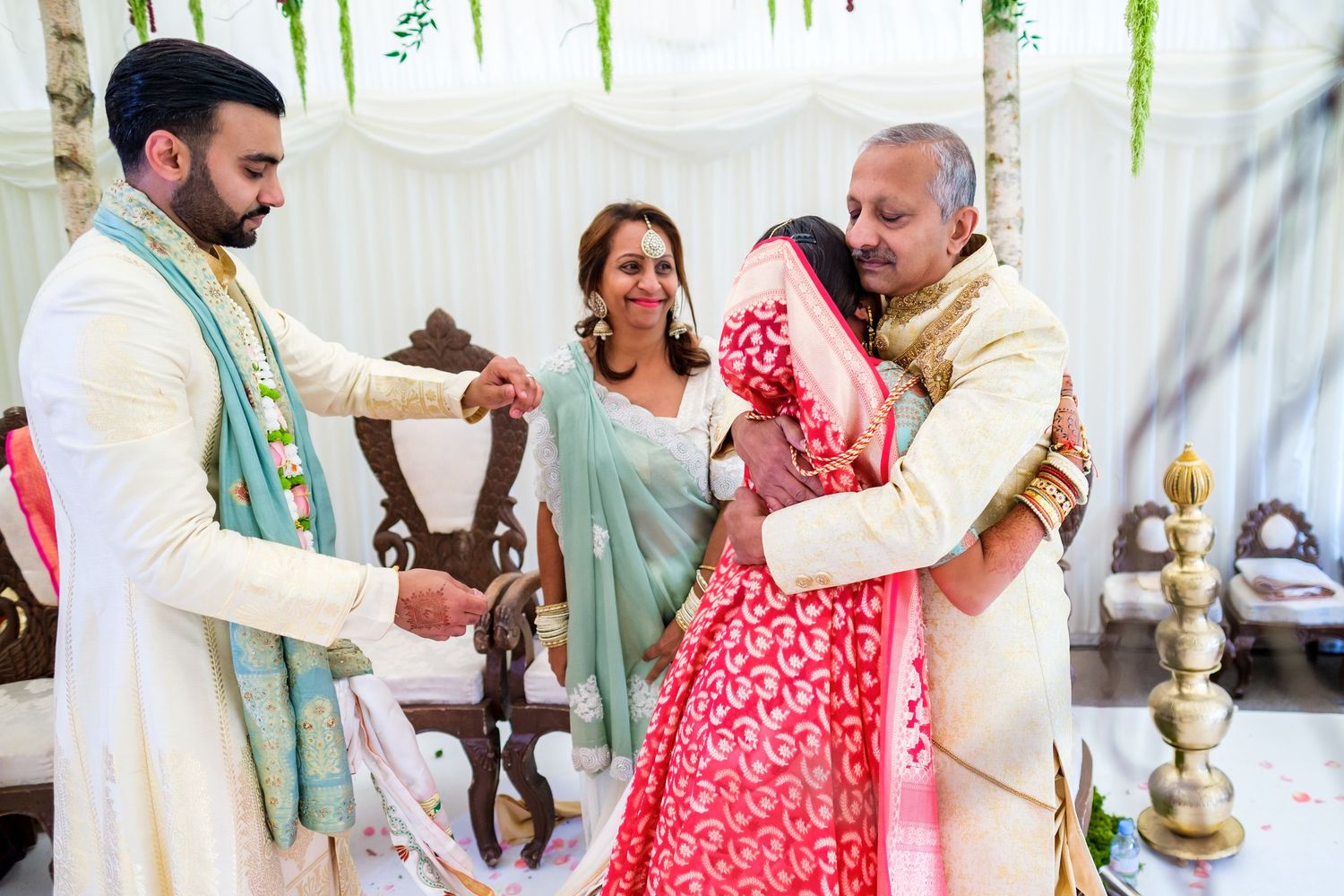 Traditional ceremony taking place under a white tent with decorative elements and cultural attire.