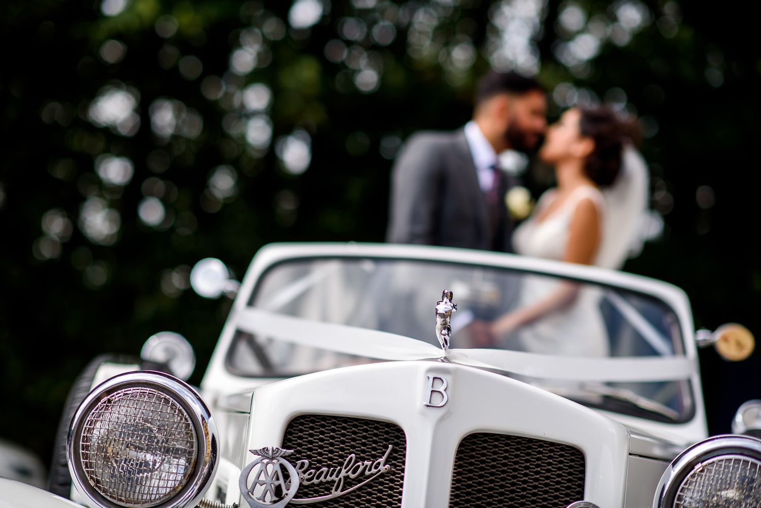 Classic vintage car detail shots at an elegant wedding ceremony.