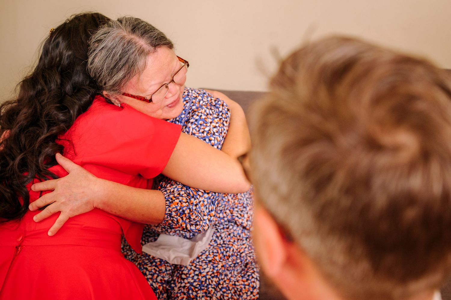 A series of candid shots showing people embracing and sharing tender moments on a striped background.