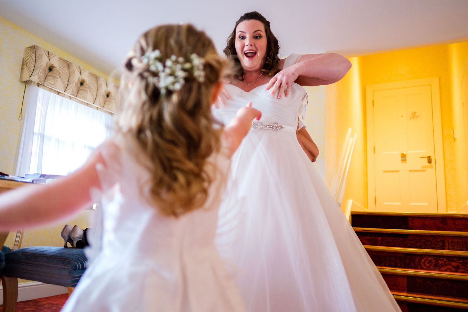 Bride getting ready in a white wedding gown with tulle skirt.