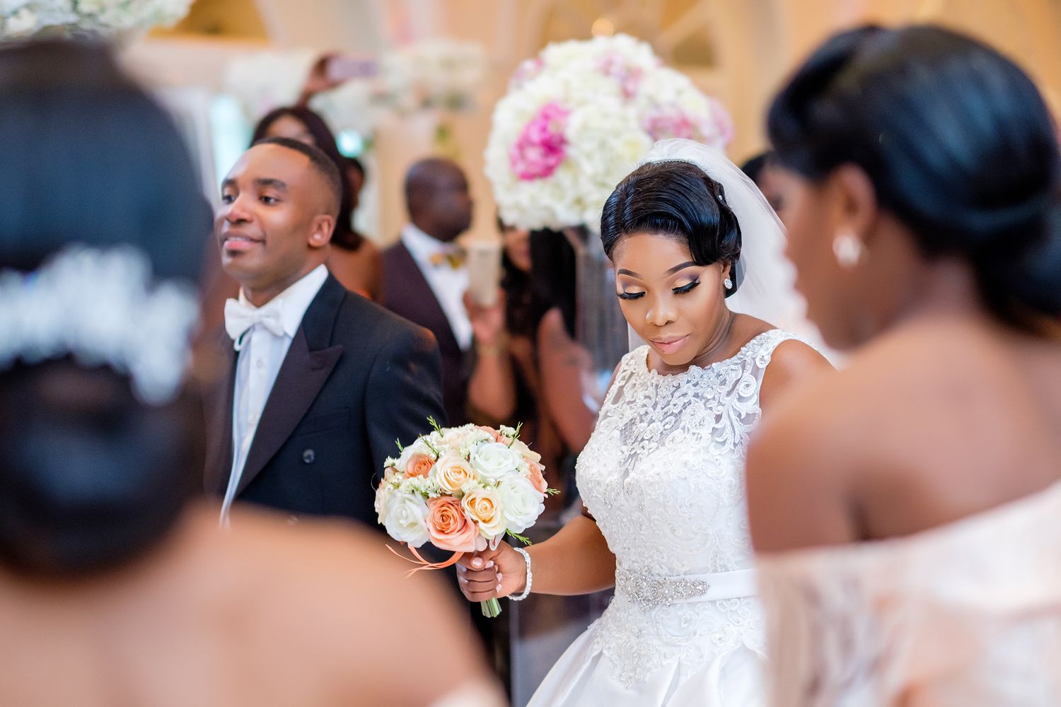 Guests enjoying themselves at a lavish wedding reception with floral decorations.