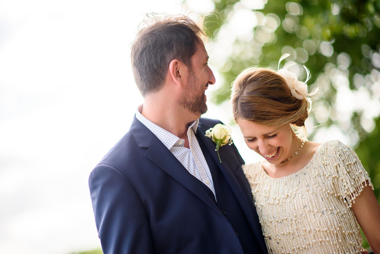 Elegant wedding couple shares tender moments outdoors at their celebration.