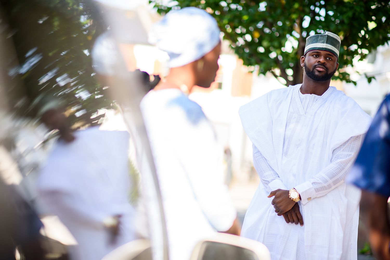 Group of people wearing white clothing standing together outdoors.