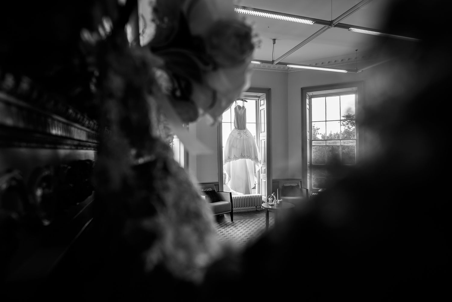 High contrast black and white interior photograph with dramatic window lighting.