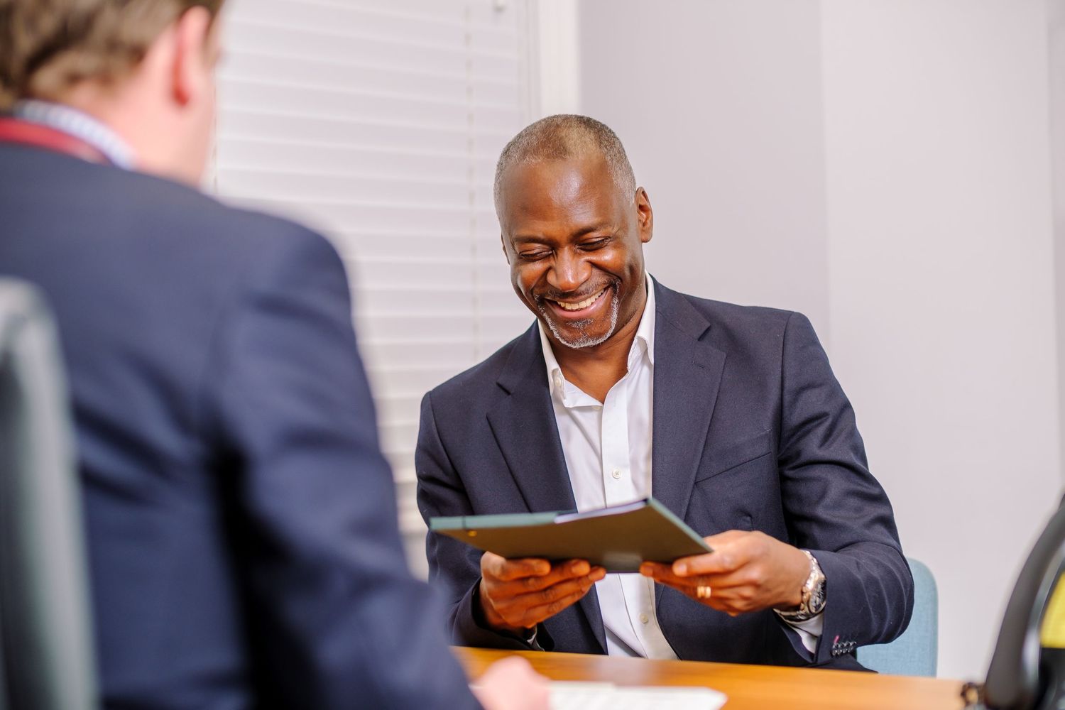 Business professionals interacting during casual meeting in office setting.