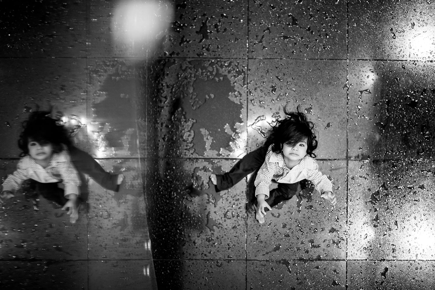 A sequence of black and white security camera footage frames showing movement in a dimly lit space.