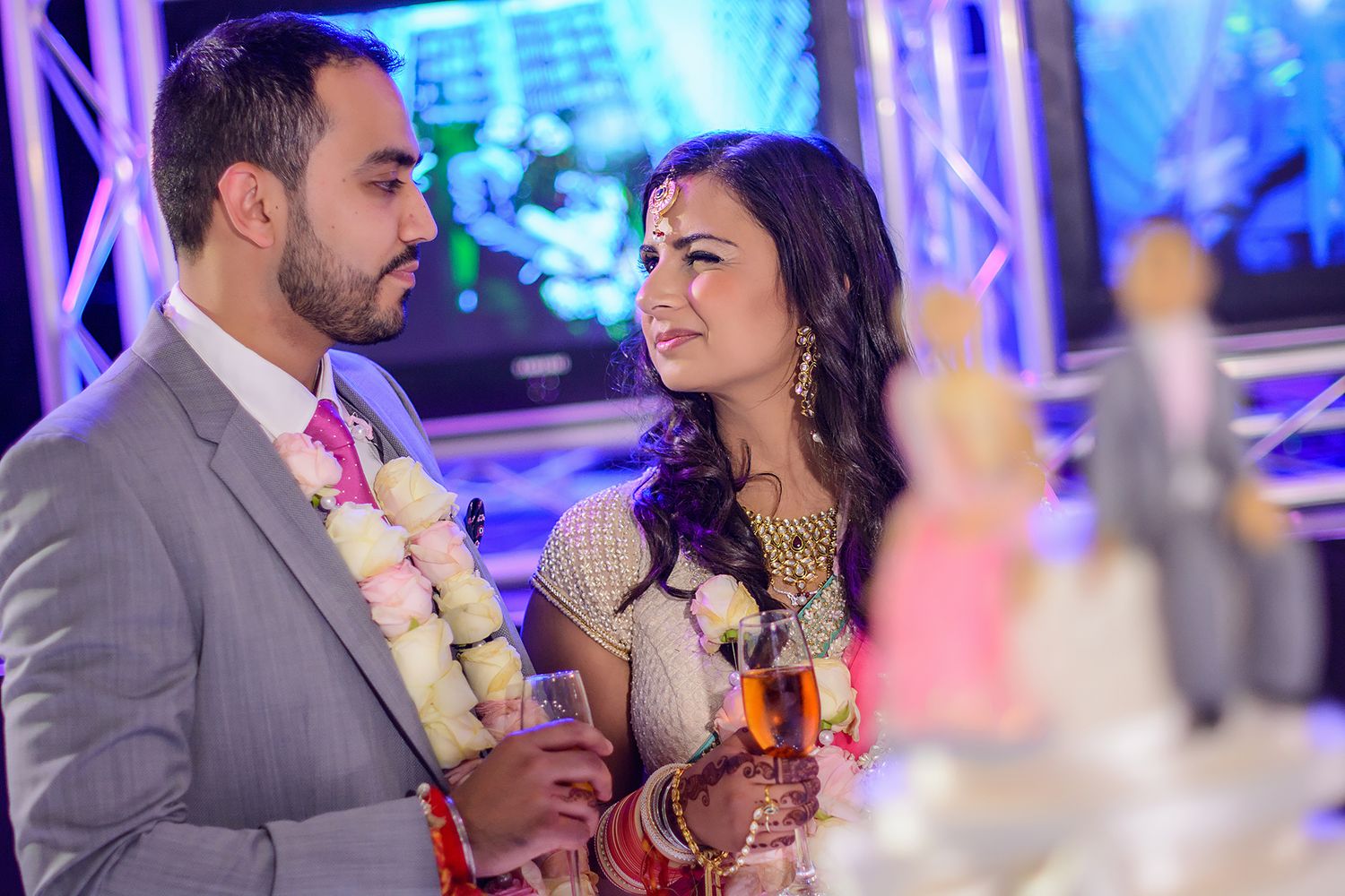 Reception celebration with purple mood lighting and elegant table settings.