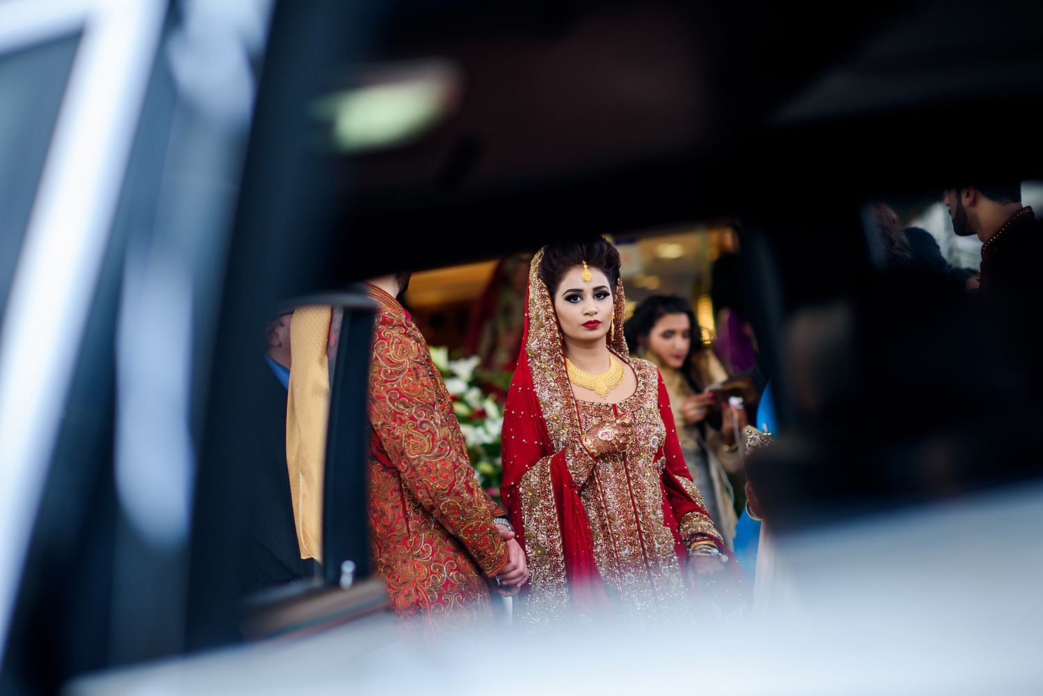 Creative framed shots of traditional wedding attire through reflective surfaces.