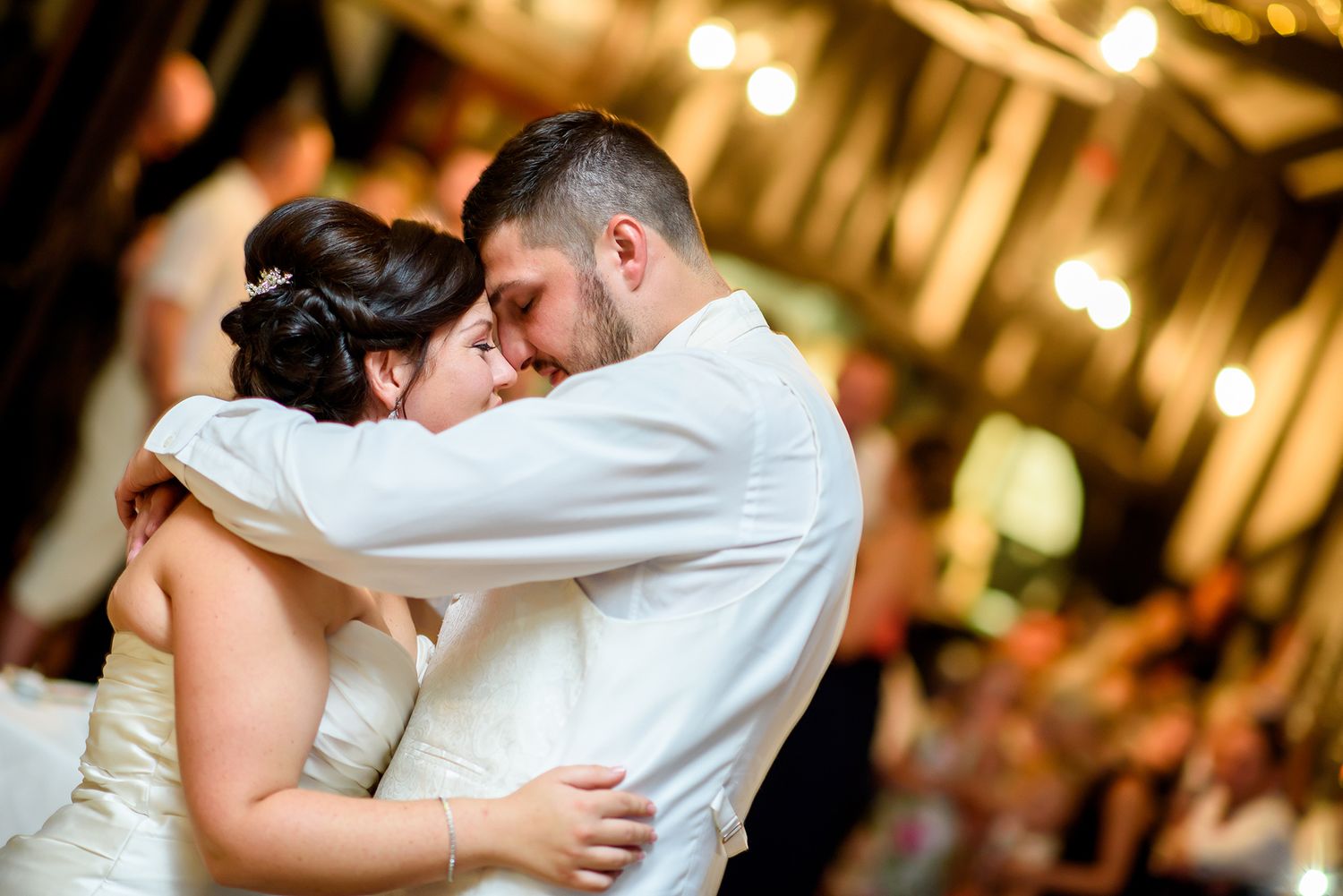 A tender first dance moment between newlyweds at their wedding reception.