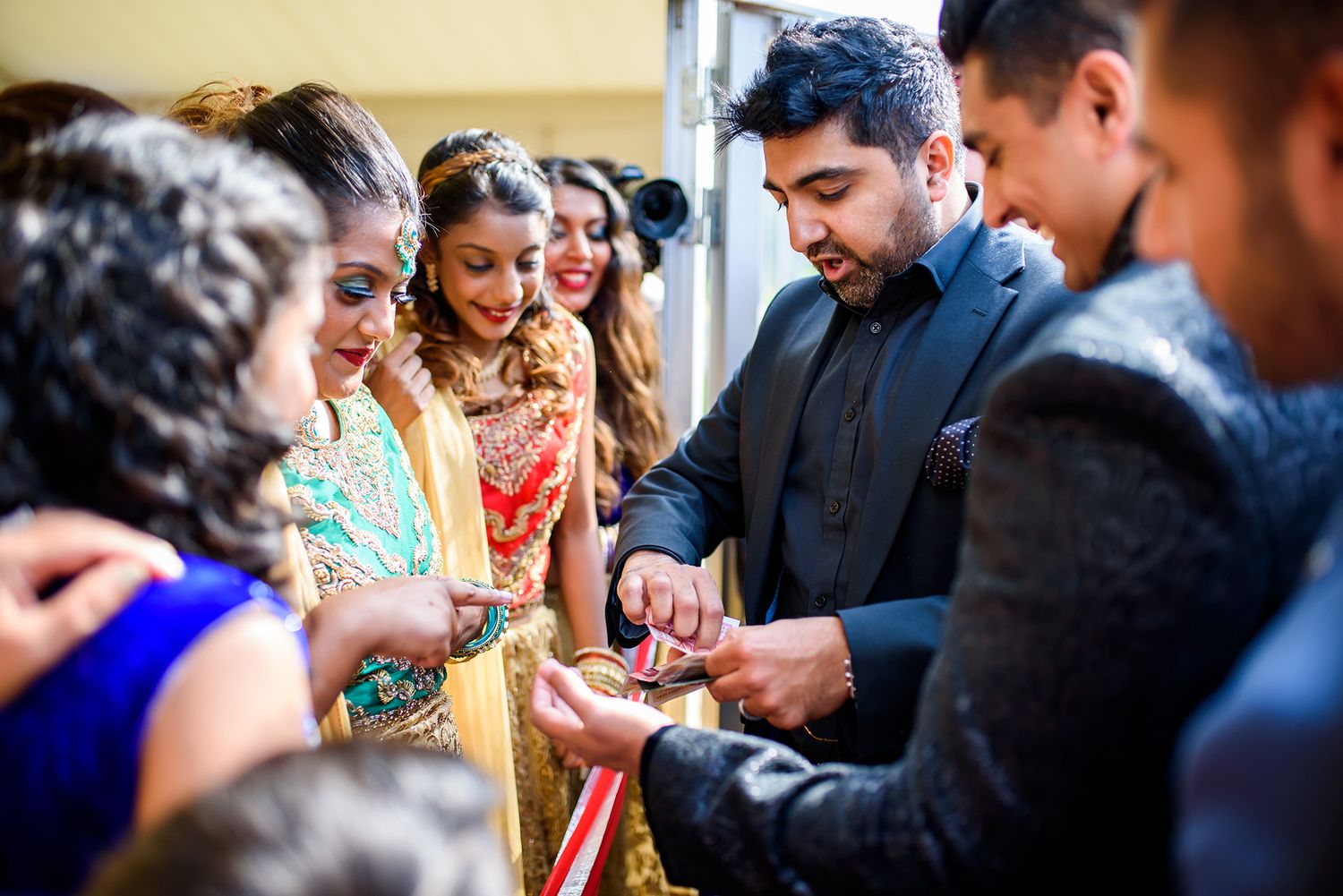 Wedding guests socializing and celebrating indoors during a reception.