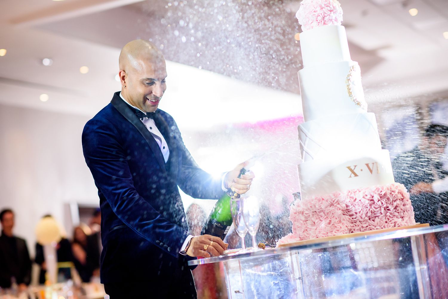 Champagne towers being filled with sparkling wine at a luxurious event.