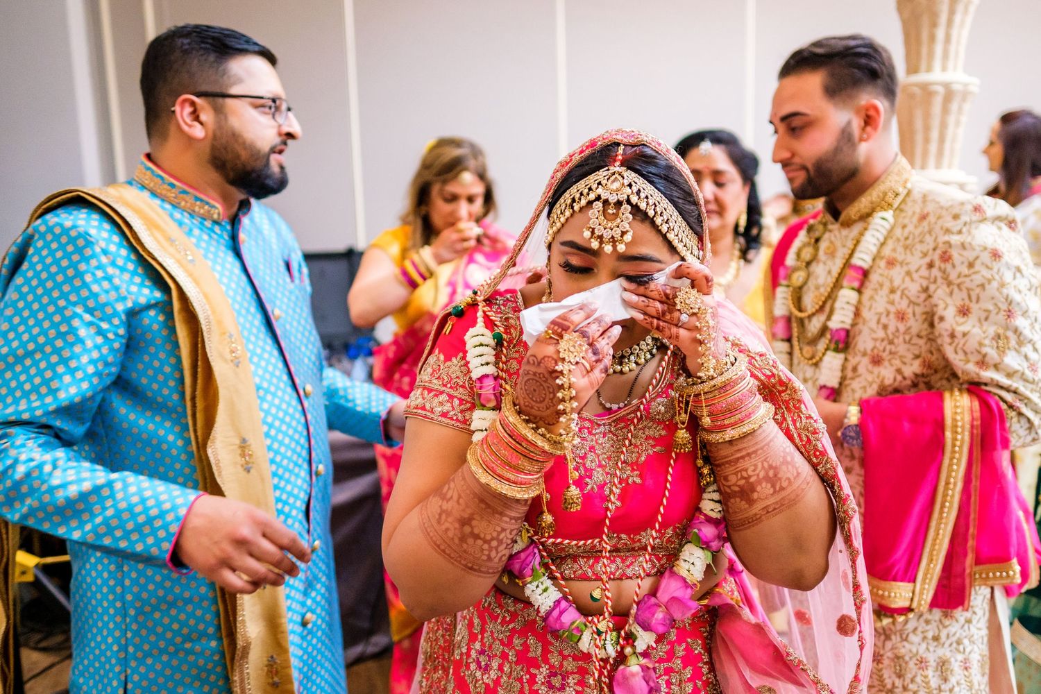Traditional Indian wedding ceremony with guests wearing colorful attire and cultural decorations.