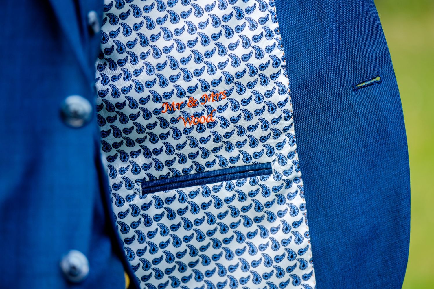 Detail shot of a bright blue suit jacket with patterned lining.