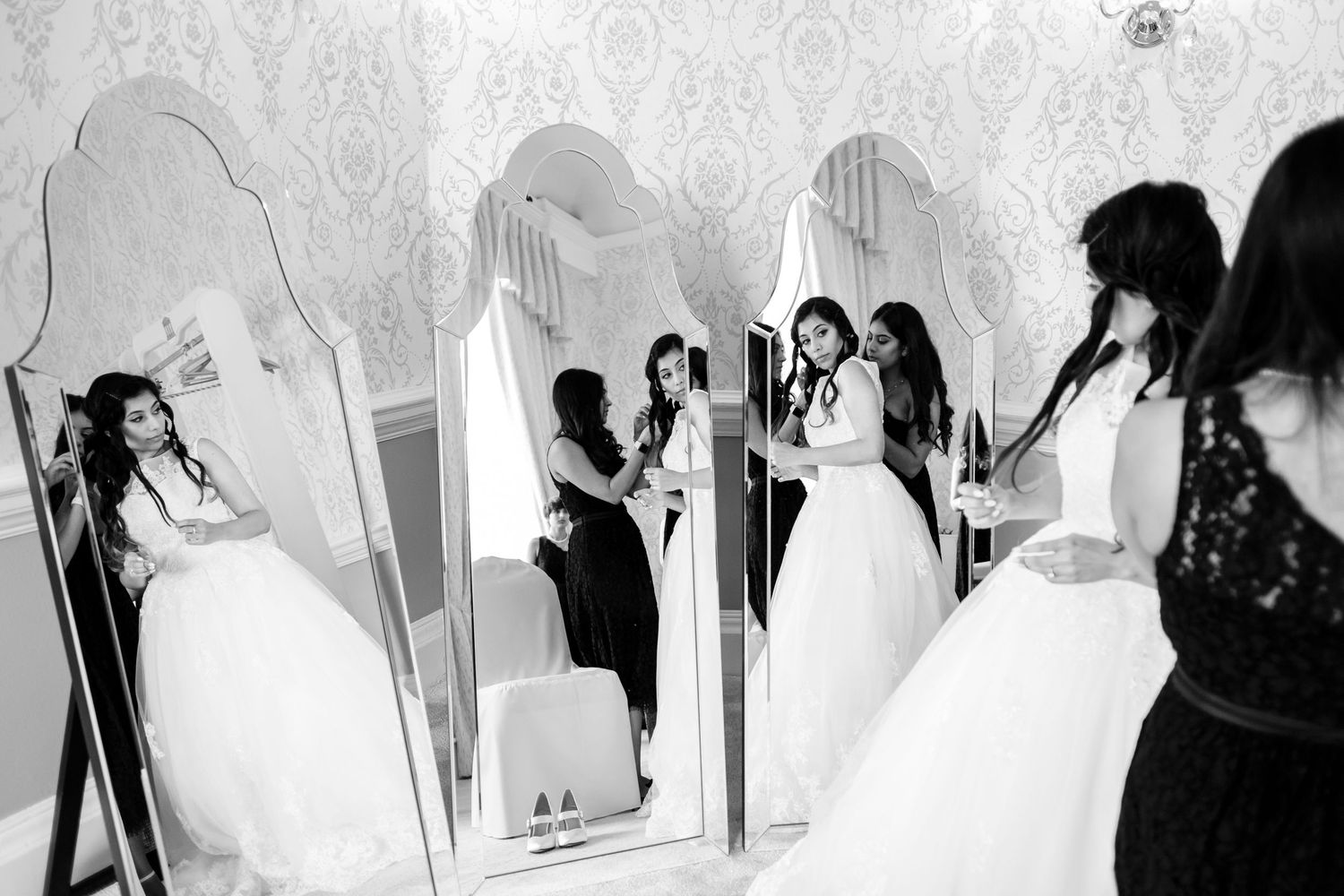 Romantic wedding ceremony and reception moments captured in an elegant ballroom with dramatic lighting.