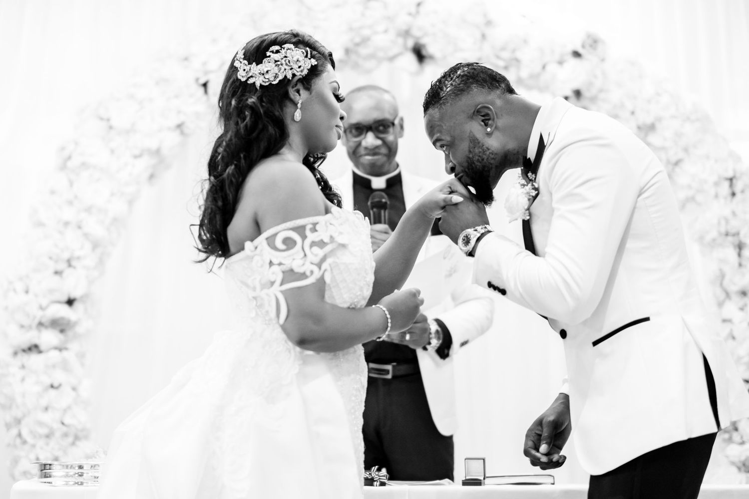 Candid black and white photos showing wedding guests dancing and celebrating at reception.