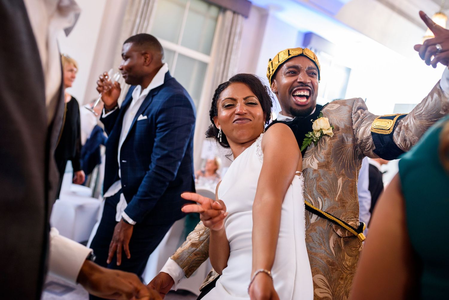 Candid moments of wedding guests enjoying themselves during reception festivities.