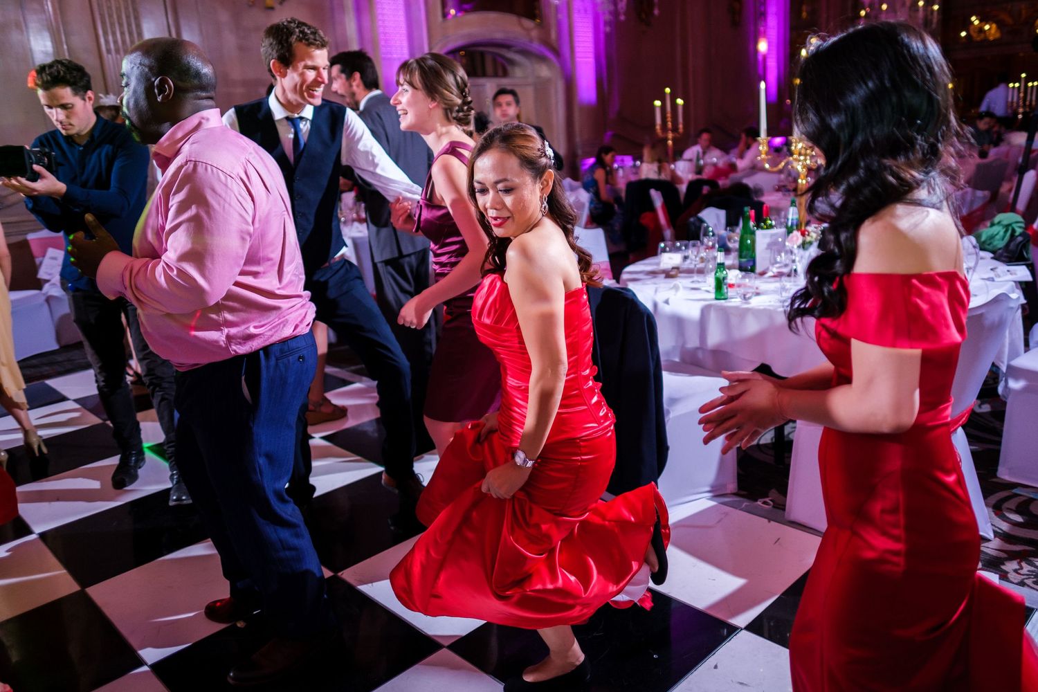 Wedding reception dance floor with purple lighting and guests enjoying celebrations.