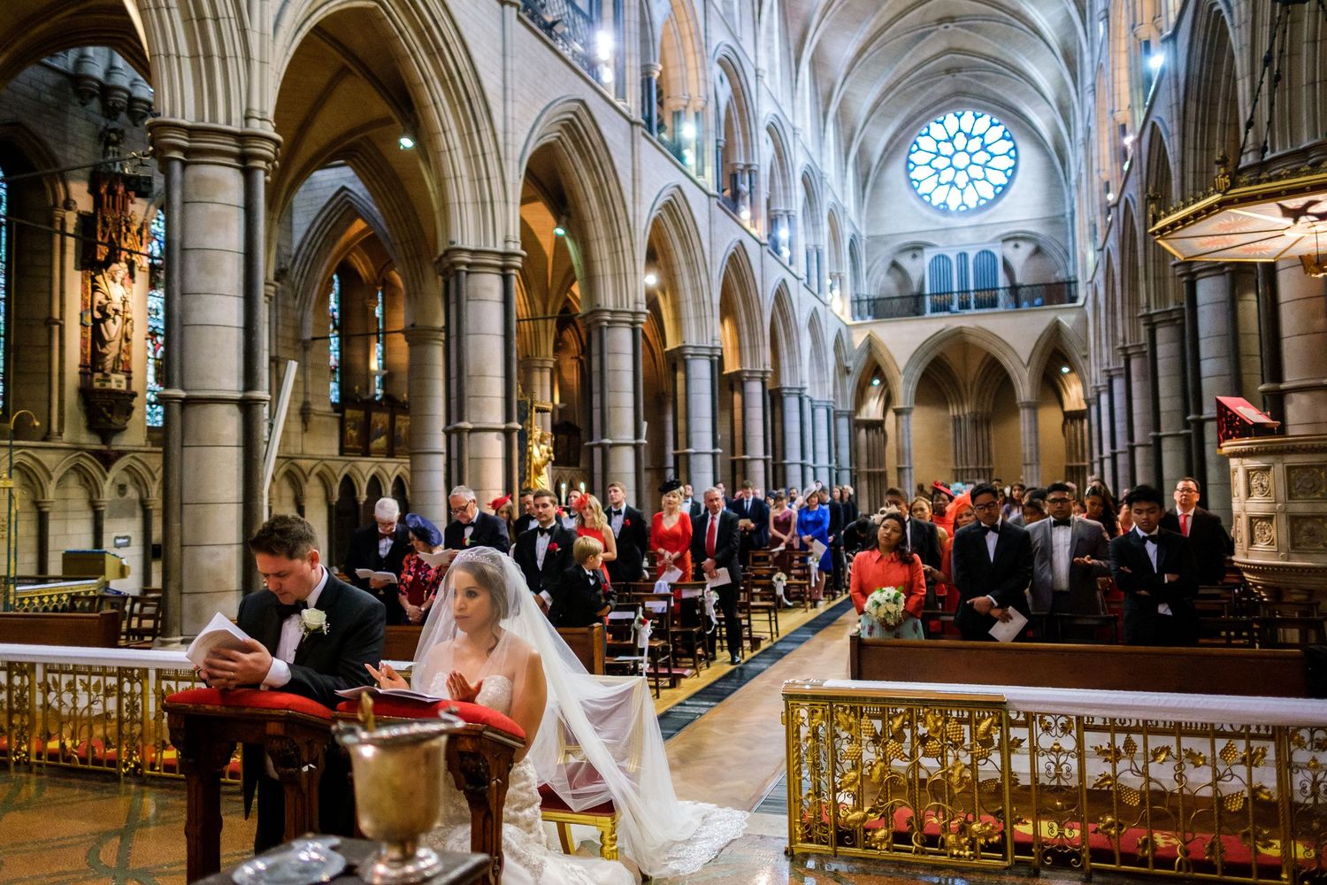 Panoramic view of gothic cathedral interior with arched columns and ornate architectural details.