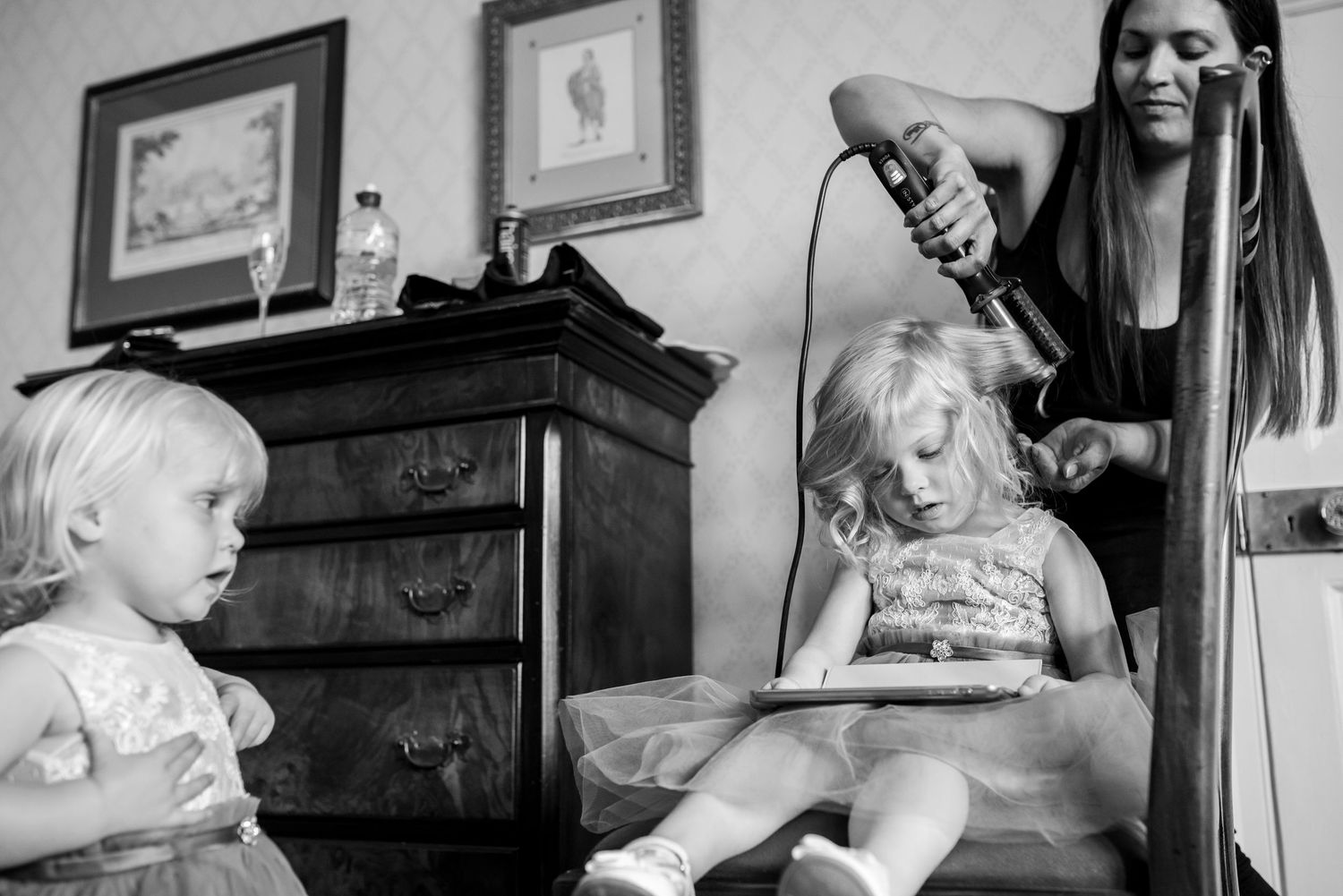 Black and white photographs arranged in a filmstrip-like sequence showing interior domestic scenes.