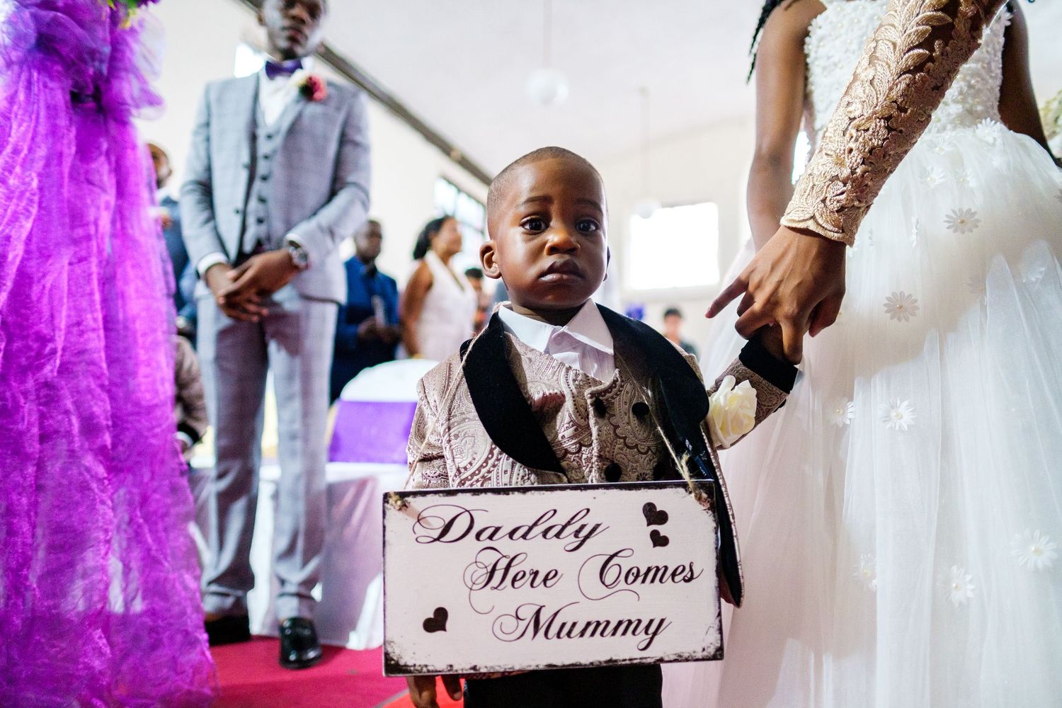 Wedding ceremony signs and decorative details in purple and white theme.