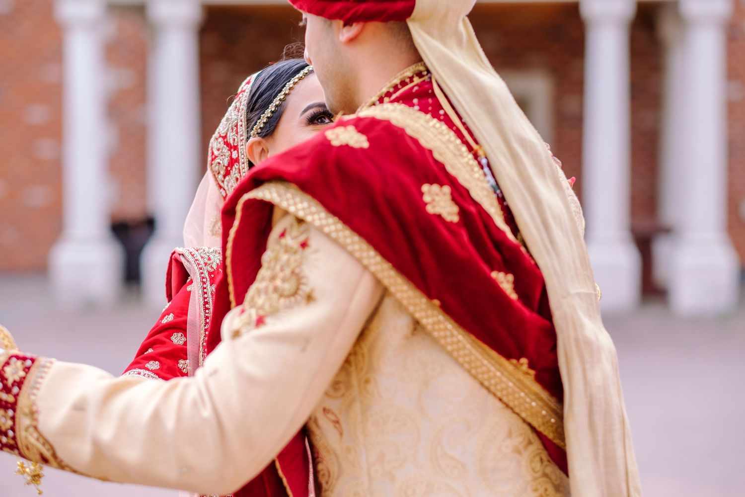 Ornate traditional wedding attire with red and gold embroidered details.