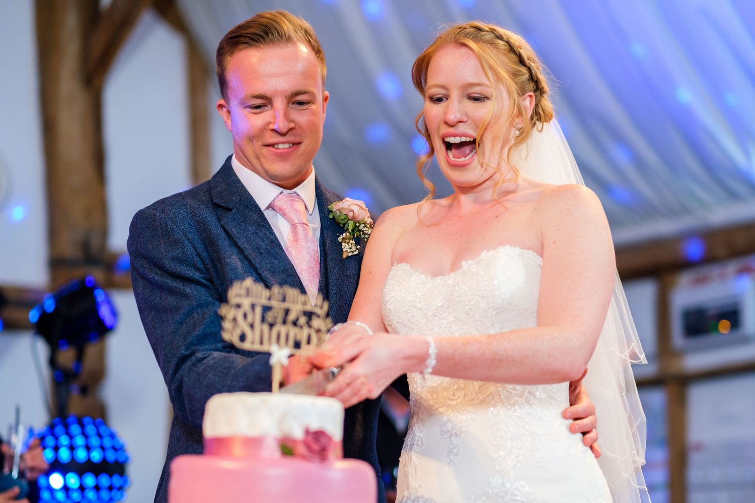 Wedding reception features blue uplighting and festive atmosphere.