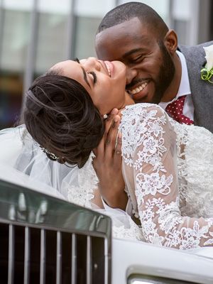 Romantic wedding couple shares intimate moments in elegant lace dress and formal attire.