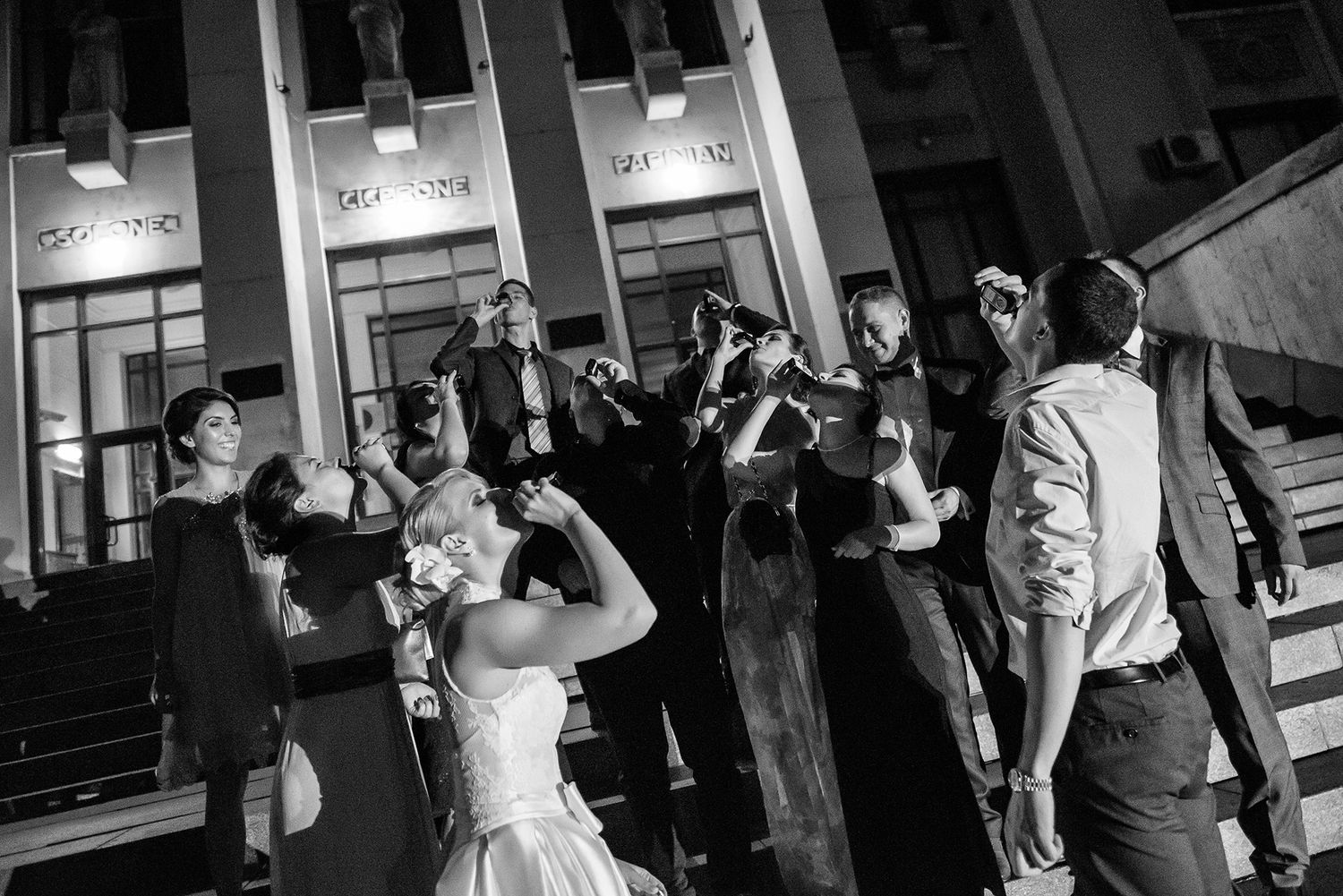 Wedding party dancing and celebrating in black and white photography.