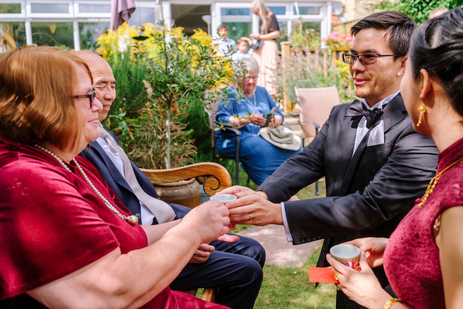 Wedding guests playing a group game at an outdoor reception.