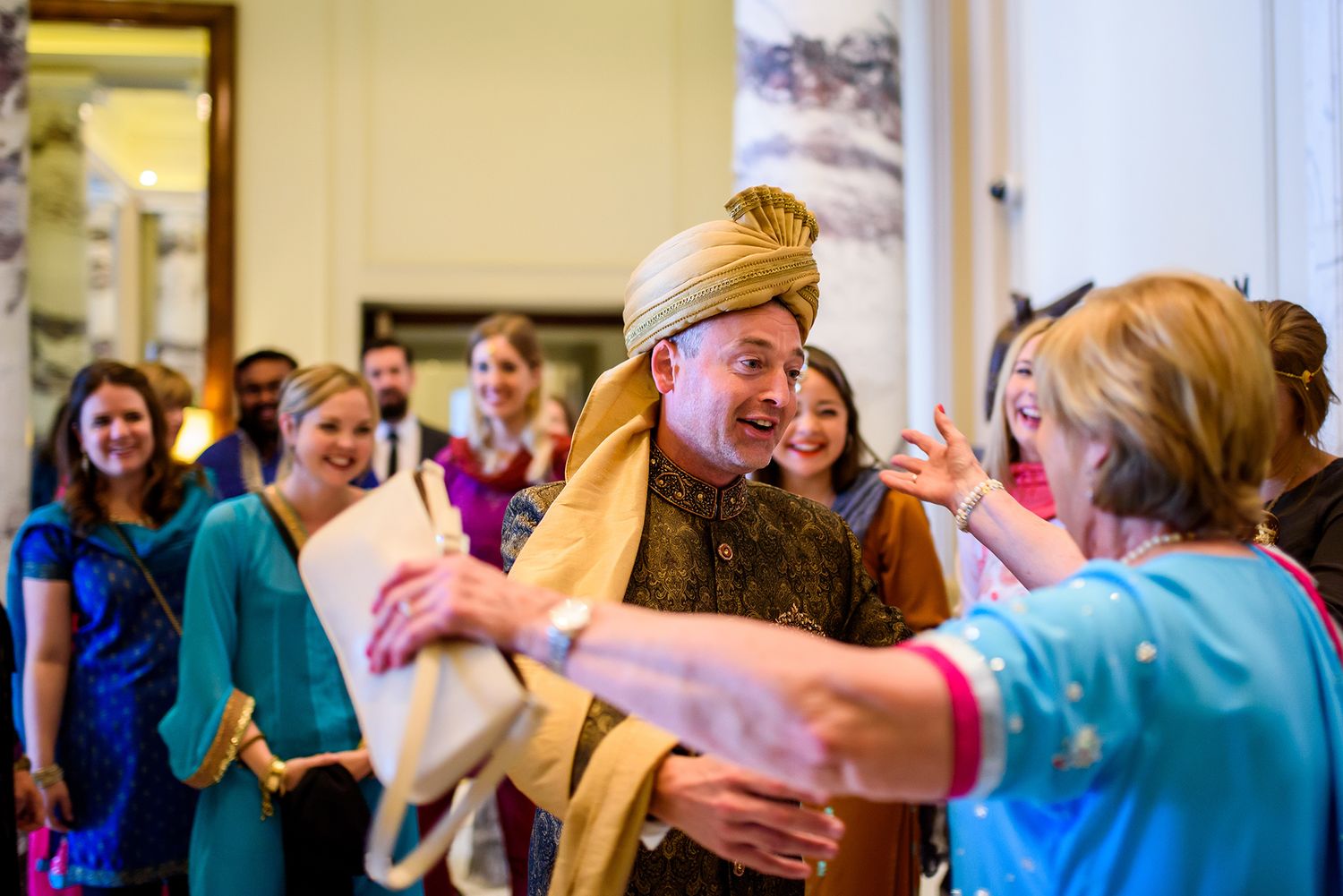 Wedding guests dancing and enjoying themselves at an elegant indoor celebration.