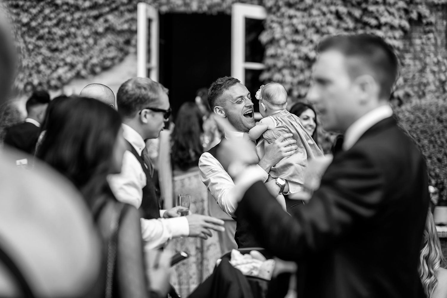 Black and white photo of couples dancing at an elegant reception.