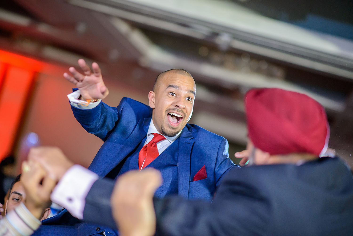 Energetic guests dancing and celebrating at a wedding reception.