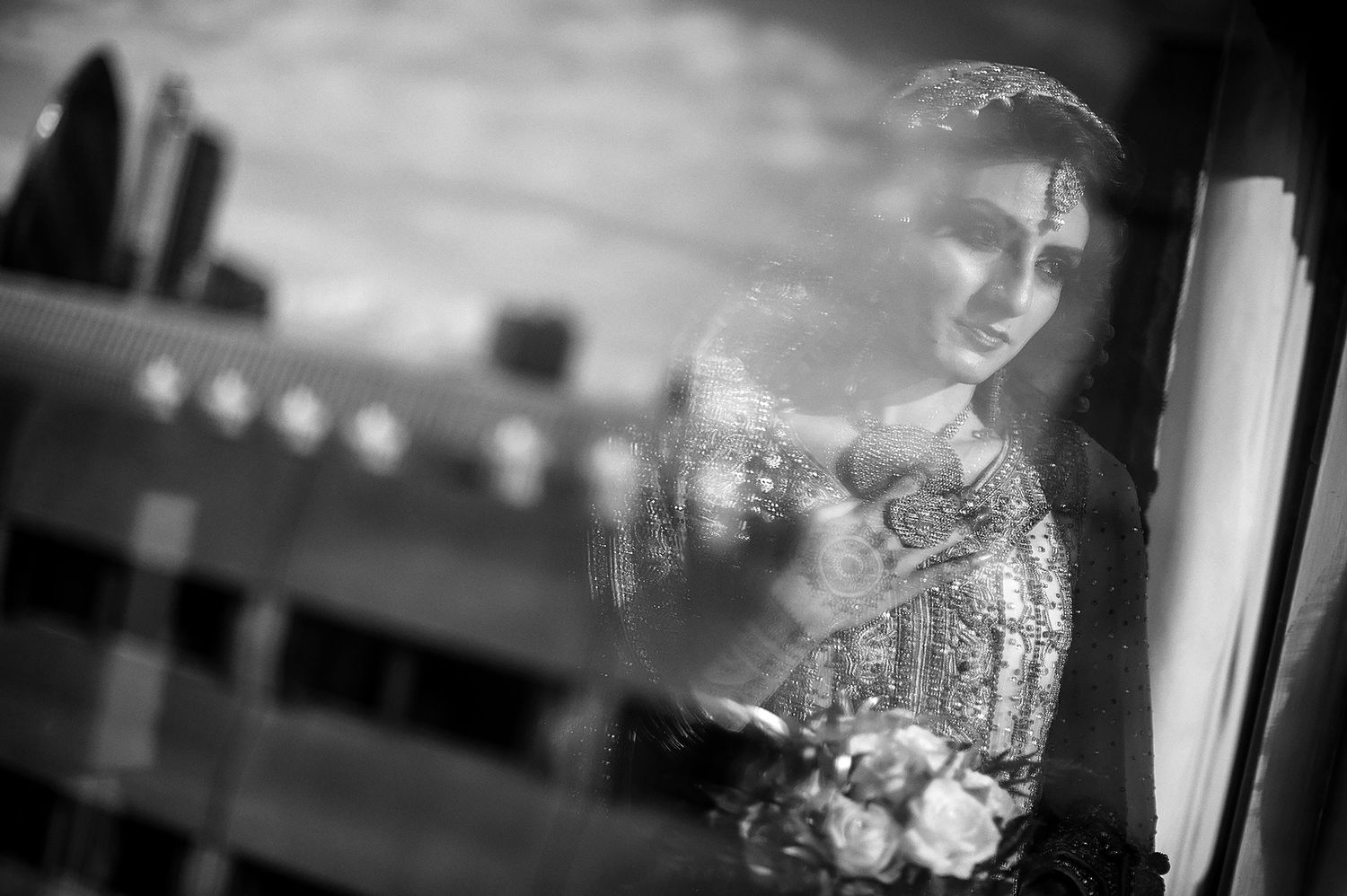 Atmospheric black and white wedding photography with window lighting.