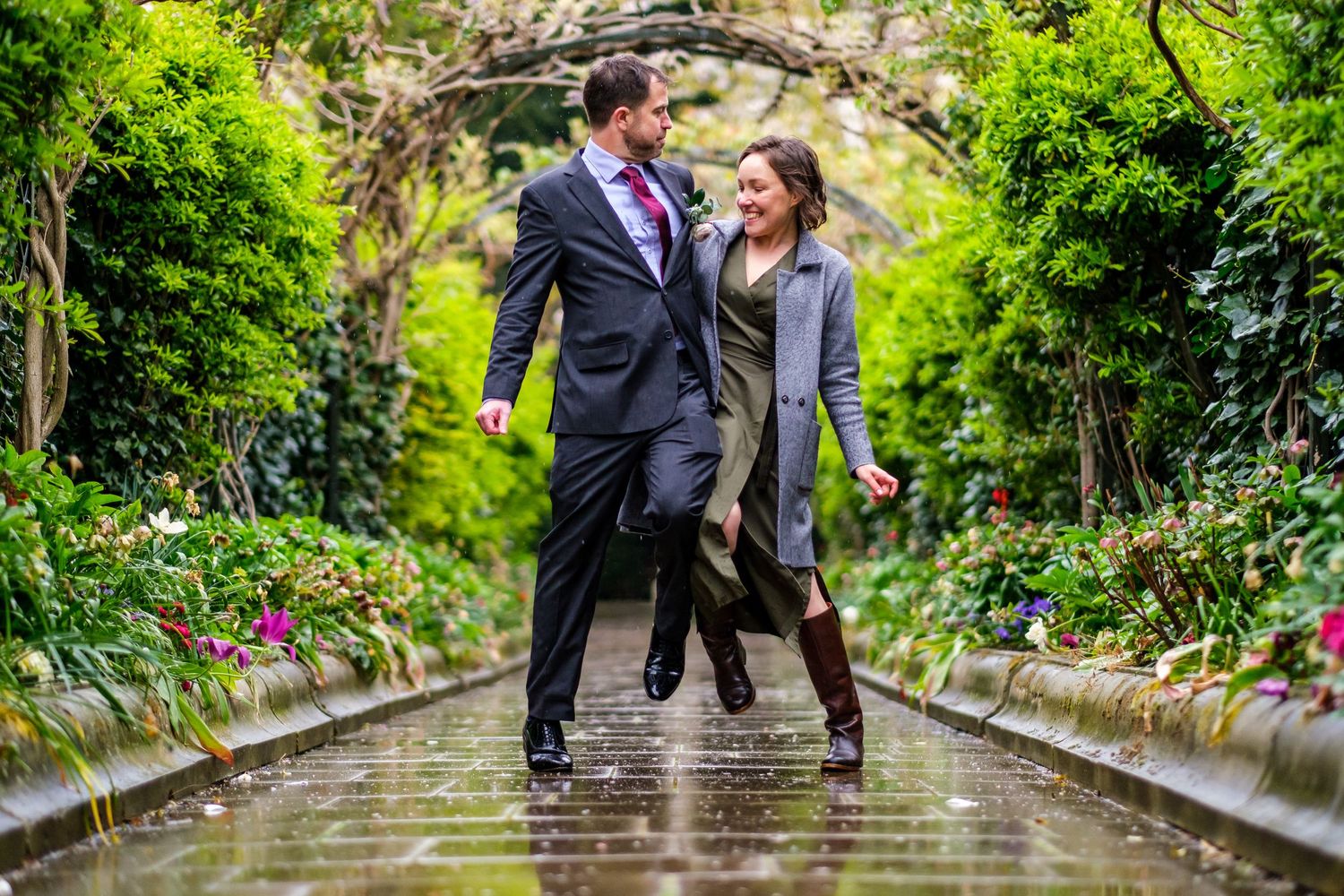 Group enjoying a special moment together on stone steps in a verdant garden pathway.