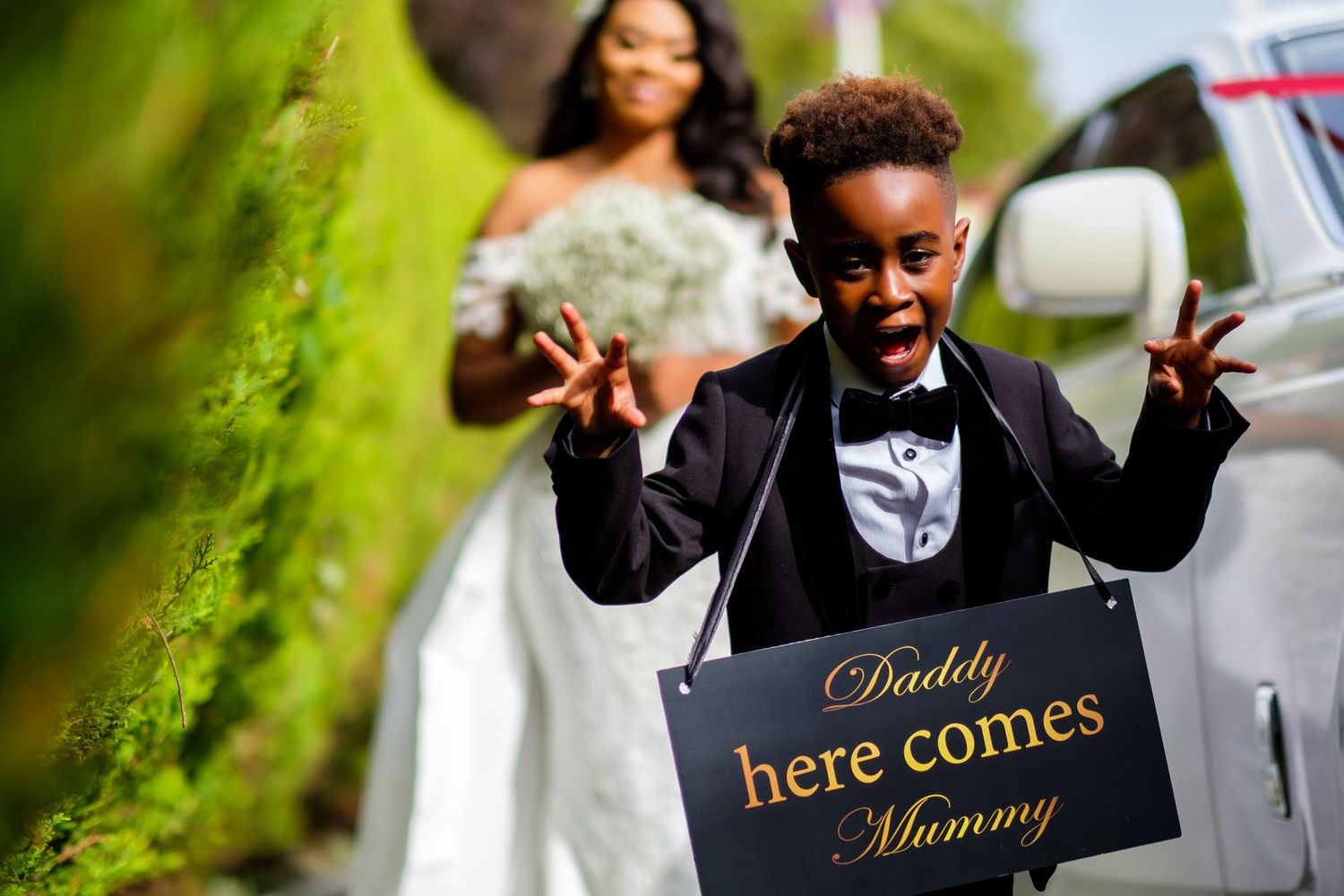 Garden wedding day preparations with signs and decorations in vibrant green outdoor setting.