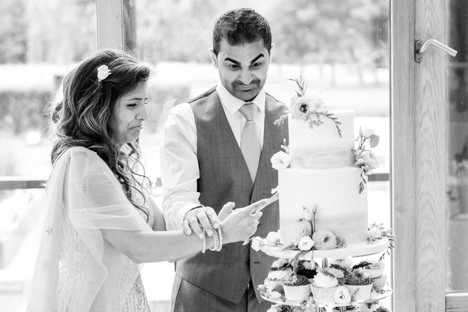 Intimate wedding moments captured in black and white photography during an outdoor ceremony.