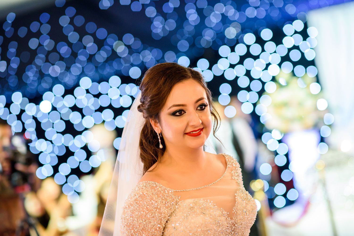 Wedding reception scene with blue bokeh lights creating a romantic atmosphere.