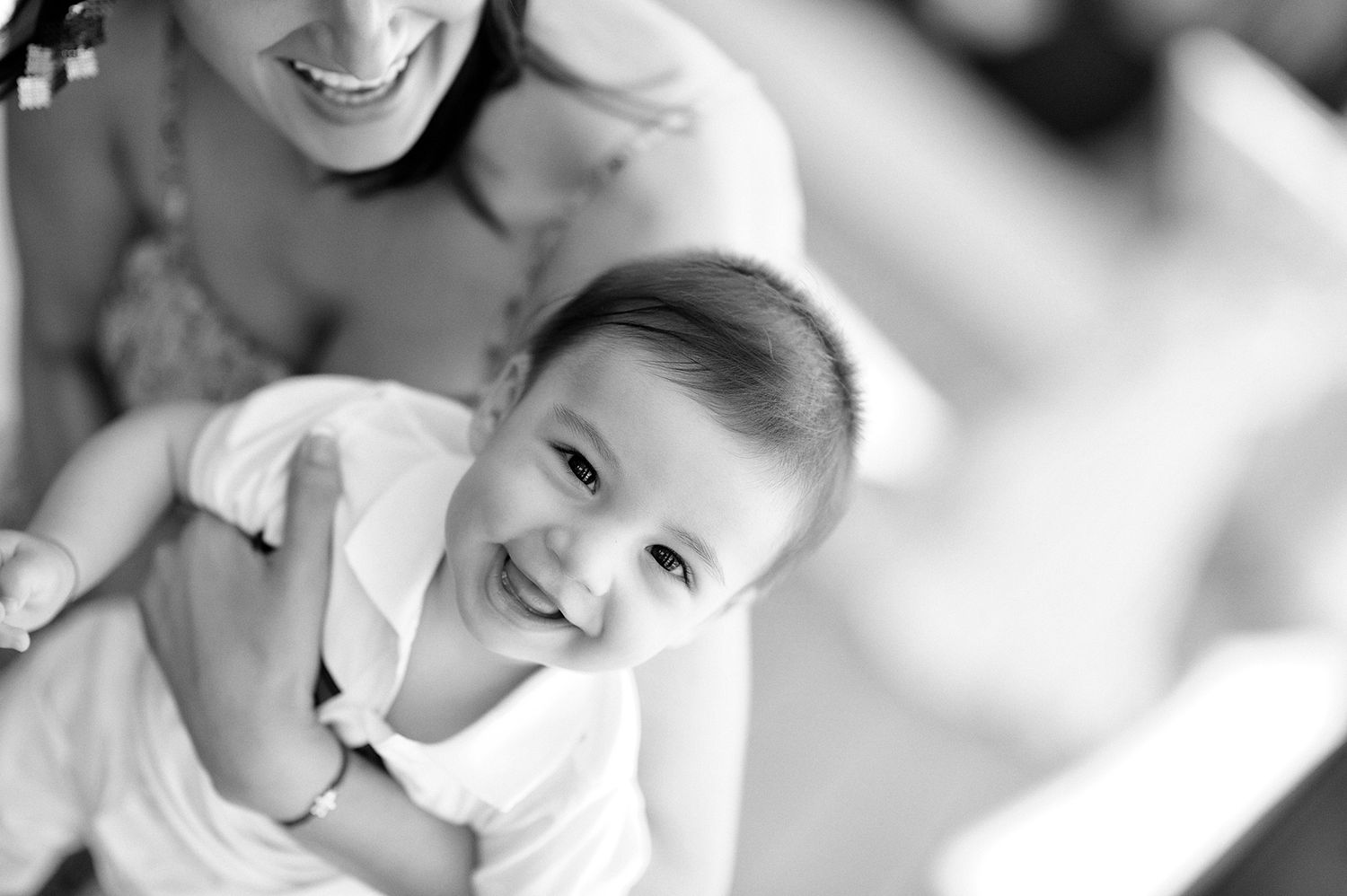 Close-up portrait shots capturing joyful smiles and expressions in black and white.