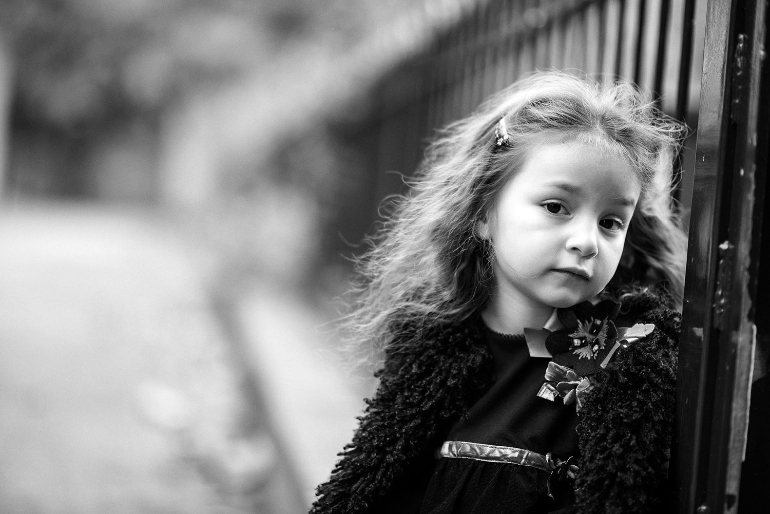 Moody black and white portrait series featuring expressive faces against a dark background.