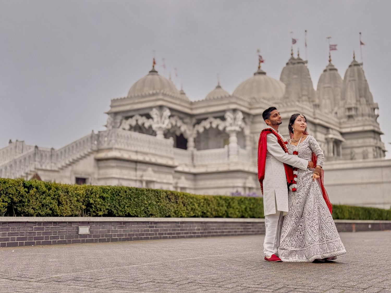 Panoramic view of BAPS Shri Swaminarayan Mandir temple in London with ornate white architecture.