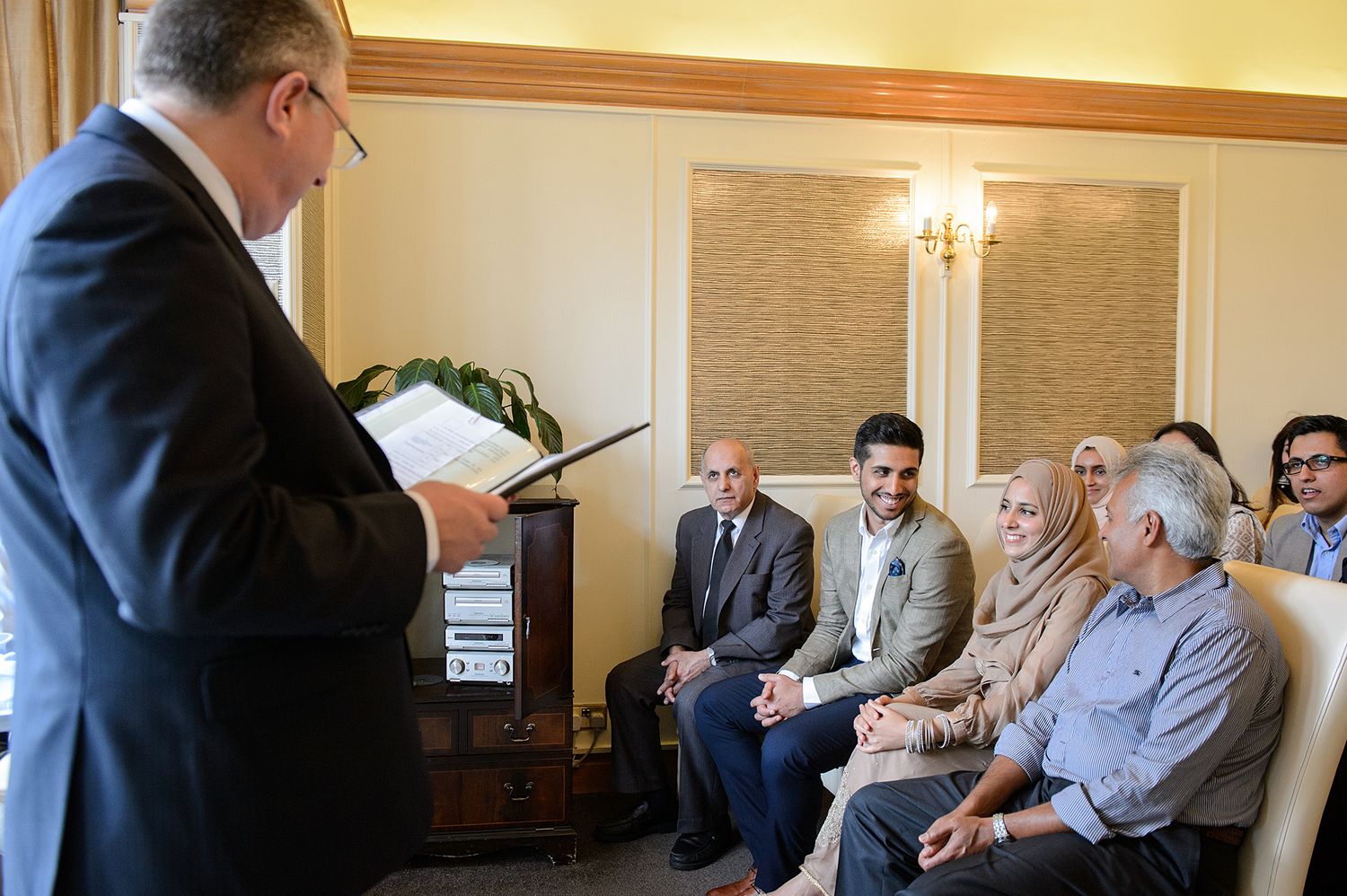 Group gathered in a meeting room with warm lighting and wood accents.
