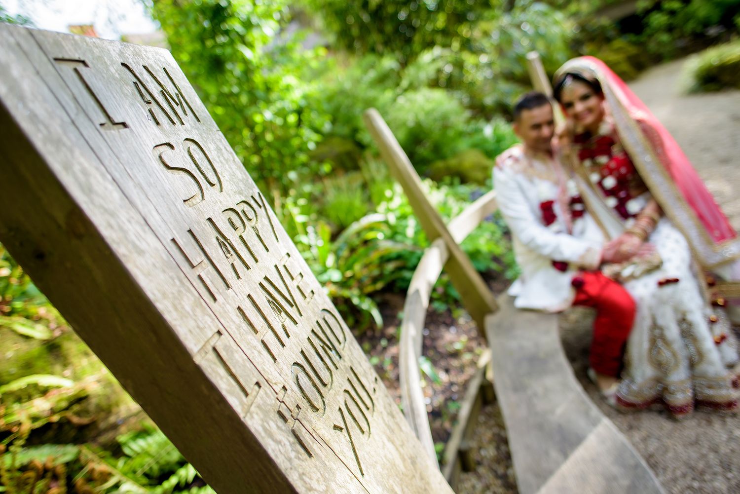 Outdoor wedding photography session near rustic wooden elements.