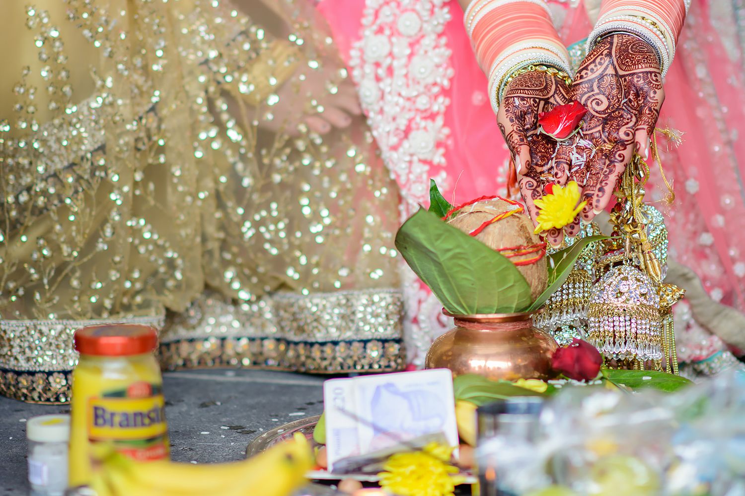 Close-up details of Indian wedding decorations with sparkly pink and gold elements.