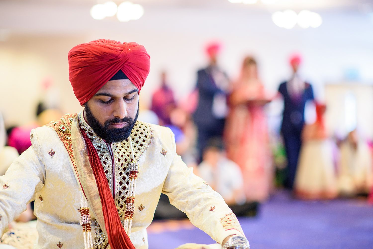Traditional wedding ceremony with ornate decorations in purple and gold.